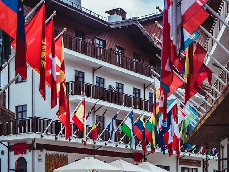 Banderas del mundo pendiendo del borde de un edificio.