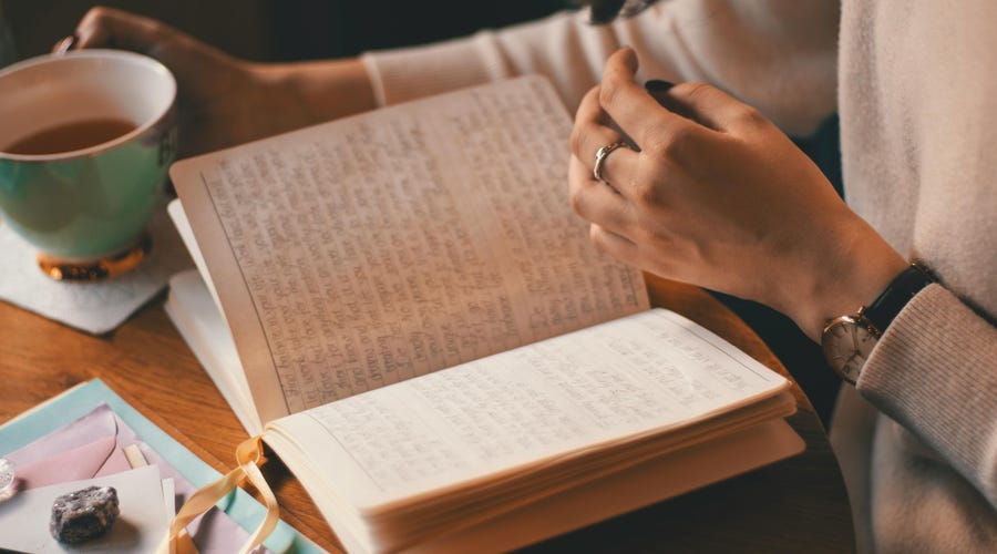 Mujer estudiando cómo crear oraciones positivas en inglés en su cuaderno.
