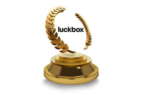 Floating luckbox logo inside of a gold laurel wreath on a pedestal to signify victory