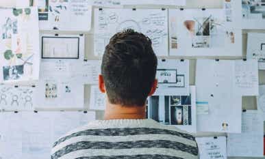 Man looking at trading plan on wall