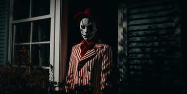 freddie halloween-like character lurking in shadows stalking human prey