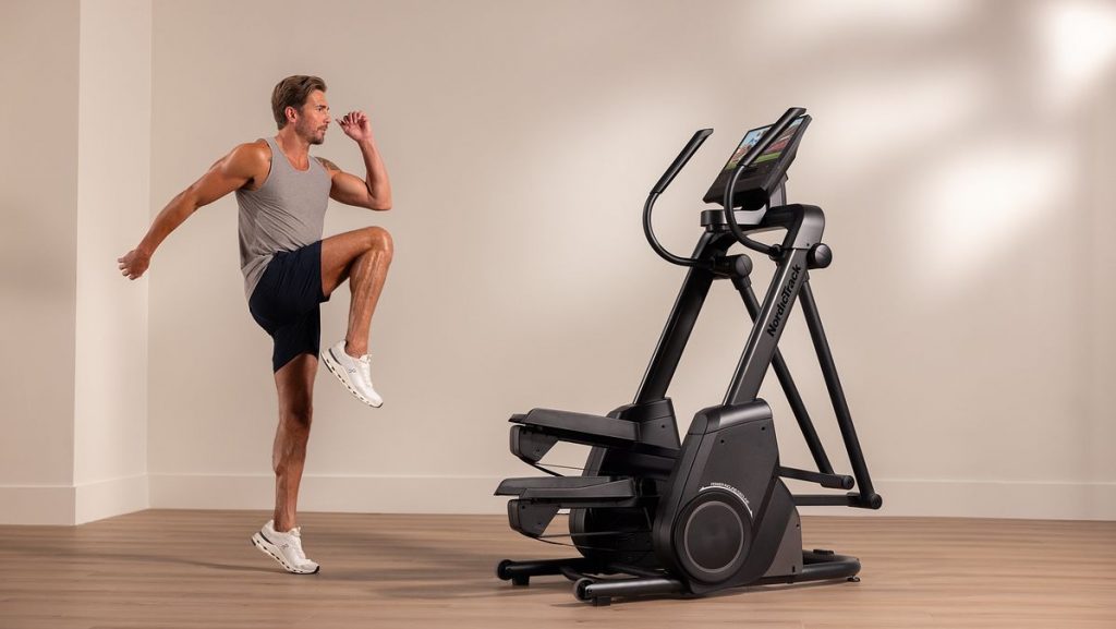 Individual performing high-intensity cardio on a NordicTrack stair climber, highlighting immersive, connected workouts.