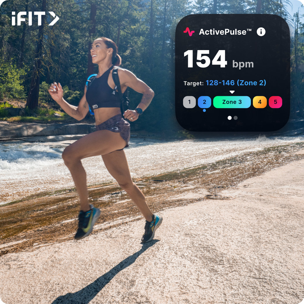 iFIT Trainer Hannah Eden running on a white road.
