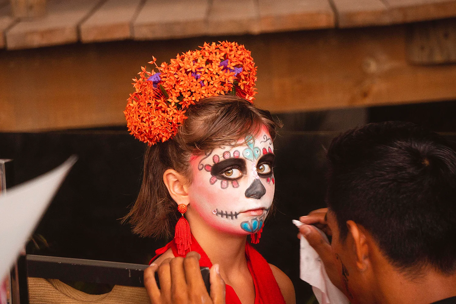Guest having her face painted as a Catrina
