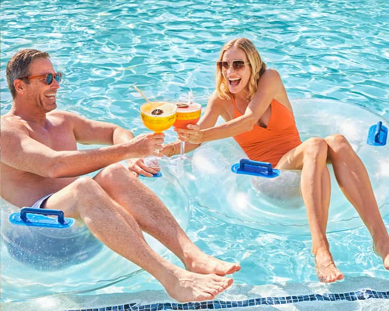 Couple toasting with cocktails at Cocoyol Bar, Jungala Aqua Experience