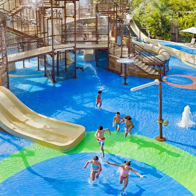 Niños corriendo en el área de juegos acuáticos de Kids Rain Fortress en Jungala Aqua Experience