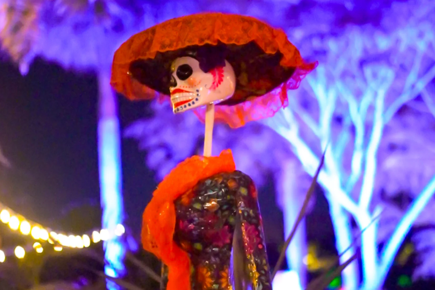 Catrina figure in a red hat