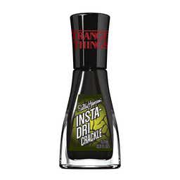 A bottle of Sally Hansen Insta-Dri Crackle nail polish with "Stranger Things" branding on the cap.