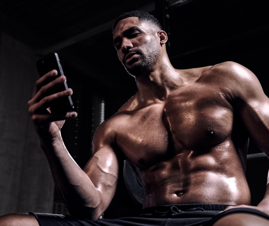 gym-man-checking-workout-phone.jpg