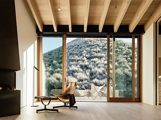 wood lift and slide door with a small mountain in the view