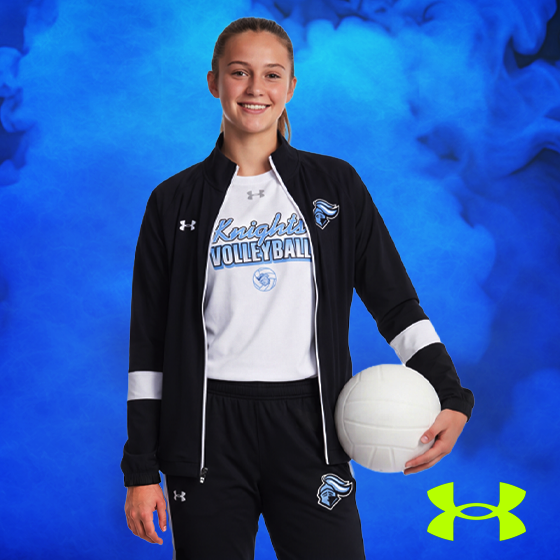 a woman volleyball player wearing a custom Under Armour volleyball shirt and jacket from BSN SPORTS and holding a volleyball