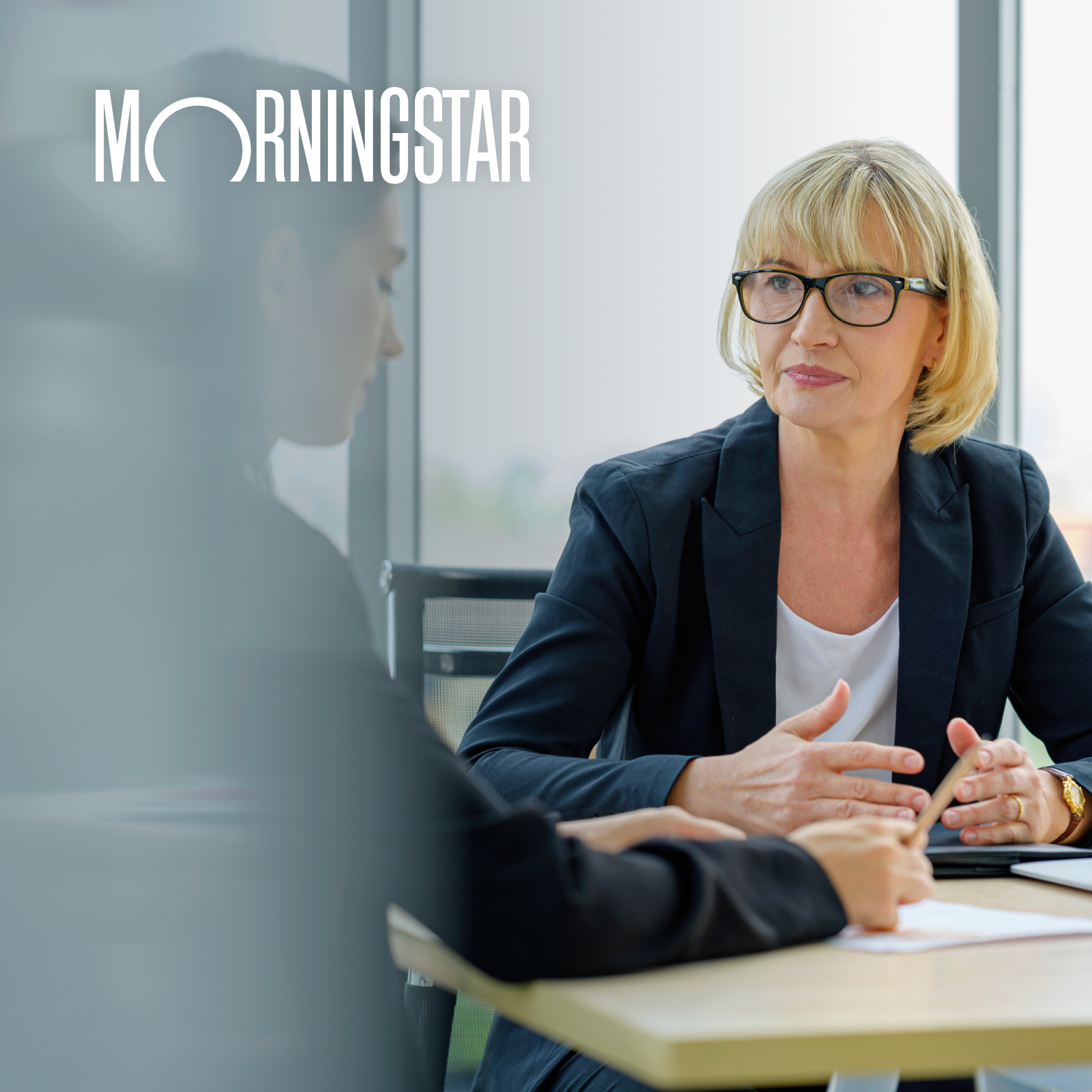 White logotype on darkened near-white photographic background.