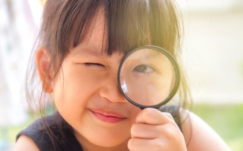 Person with dark hair outdoors. Person with dark hair outdoors.
