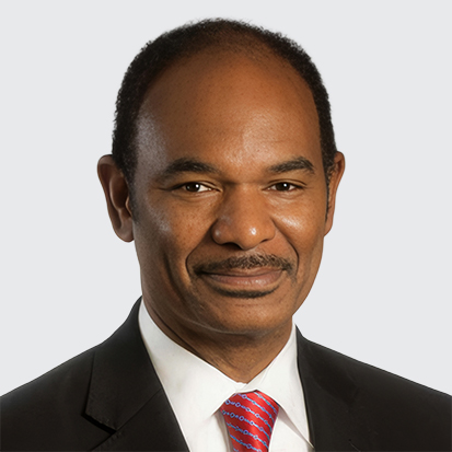 A portrait photo of a person wearing a suit and tie.