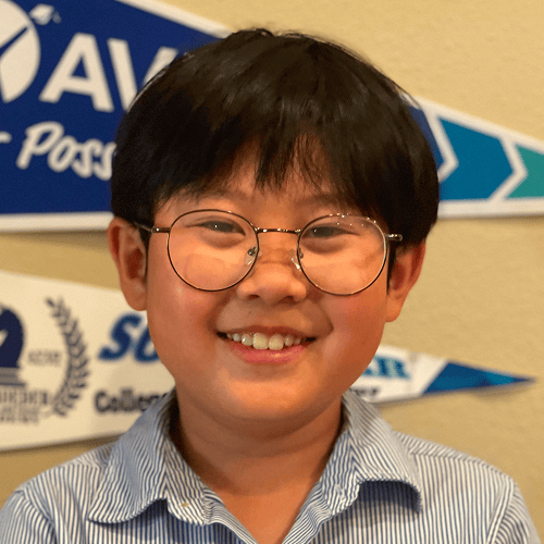 Person wearing a striped shirt with colorful banners in the background. Person wearing a striped shirt with colorful banners in the background.
