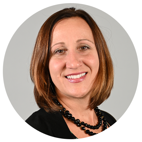 Person with shoulder-length brown hair wearing a black necklace.