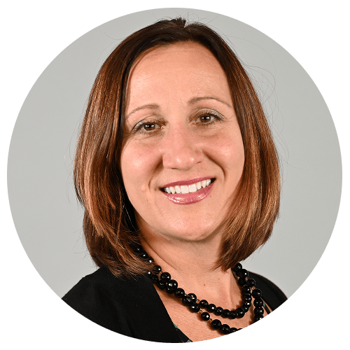 Person with shoulder-length brown hair wearing a black necklace. Person with shoulder-length brown hair wearing a black necklace.