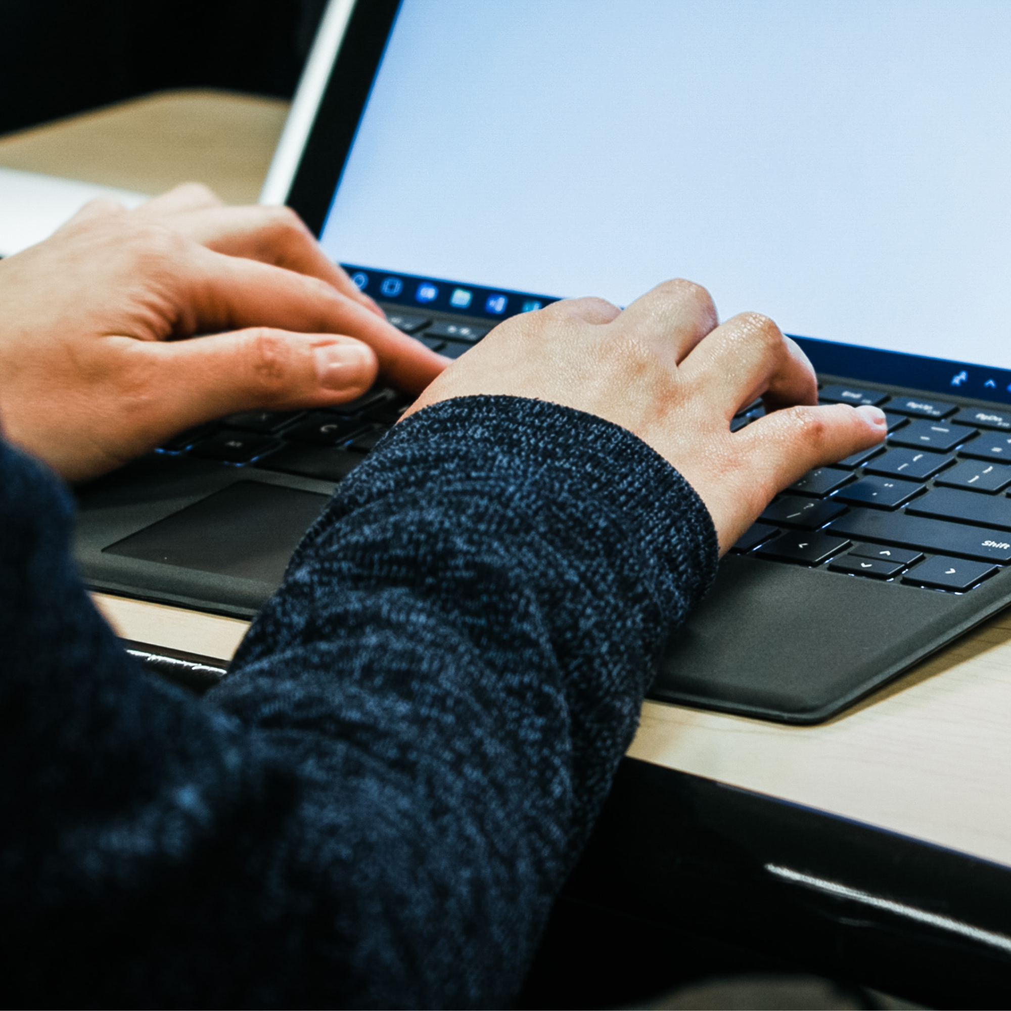 Person typing on a keyboard.
