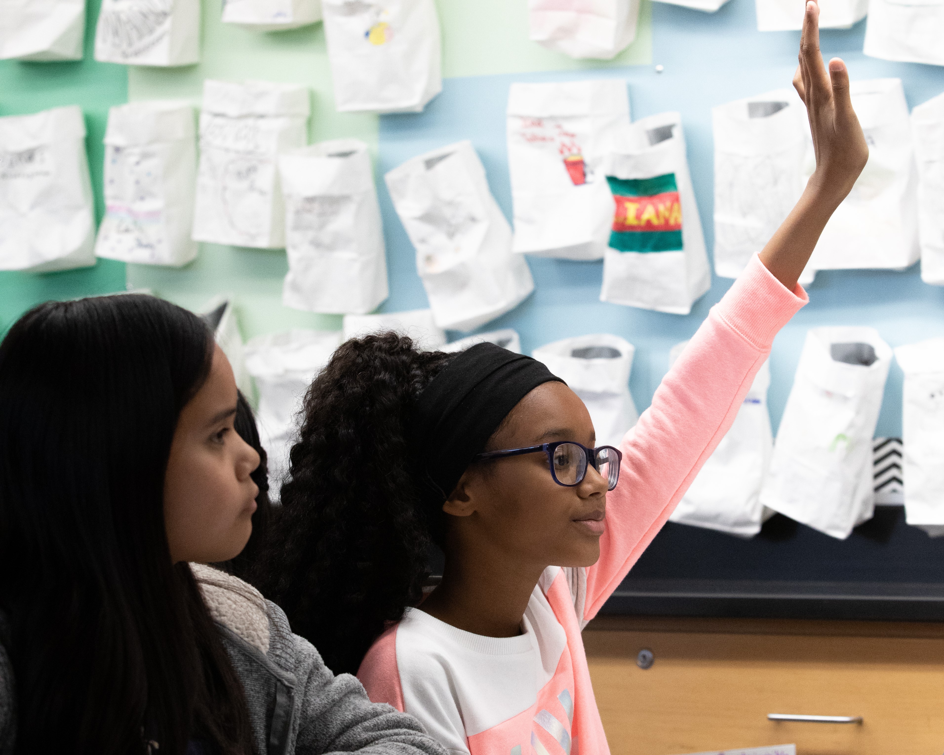 A scholar raising her hand.