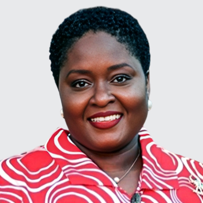 A person wearing a vibrant red shirt with white circular patterns, blurred face, and a necklace.