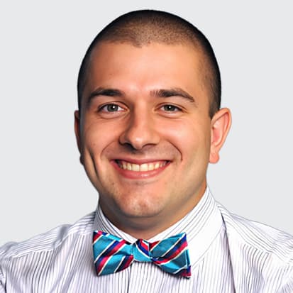 Man wearing a striped shirt and a colorful bow tie Man wearing a striped shirt and a colorful bow tie