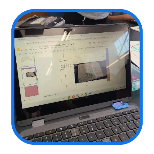 Image showing a laptop screen displaying a presentation with a diagram, held open in a web browser. The laptop has a few items placed on the keyboard. Image showing a laptop screen displaying a presentation with a diagram, held open in a web browser. The laptop has a few items placed on the keyboard.