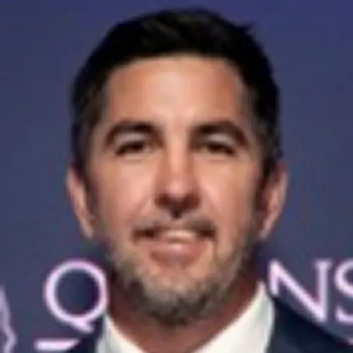 Blurry photo of a person in front of a backdrop with text. Blurry photo of a person in front of a backdrop with text.