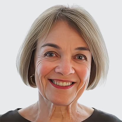 Headshot of a person with short, light-colored hair wearing a dark-colored top against a neutral background. Headshot of a person with short, light-colored hair wearing a dark-colored top against a neutral background.