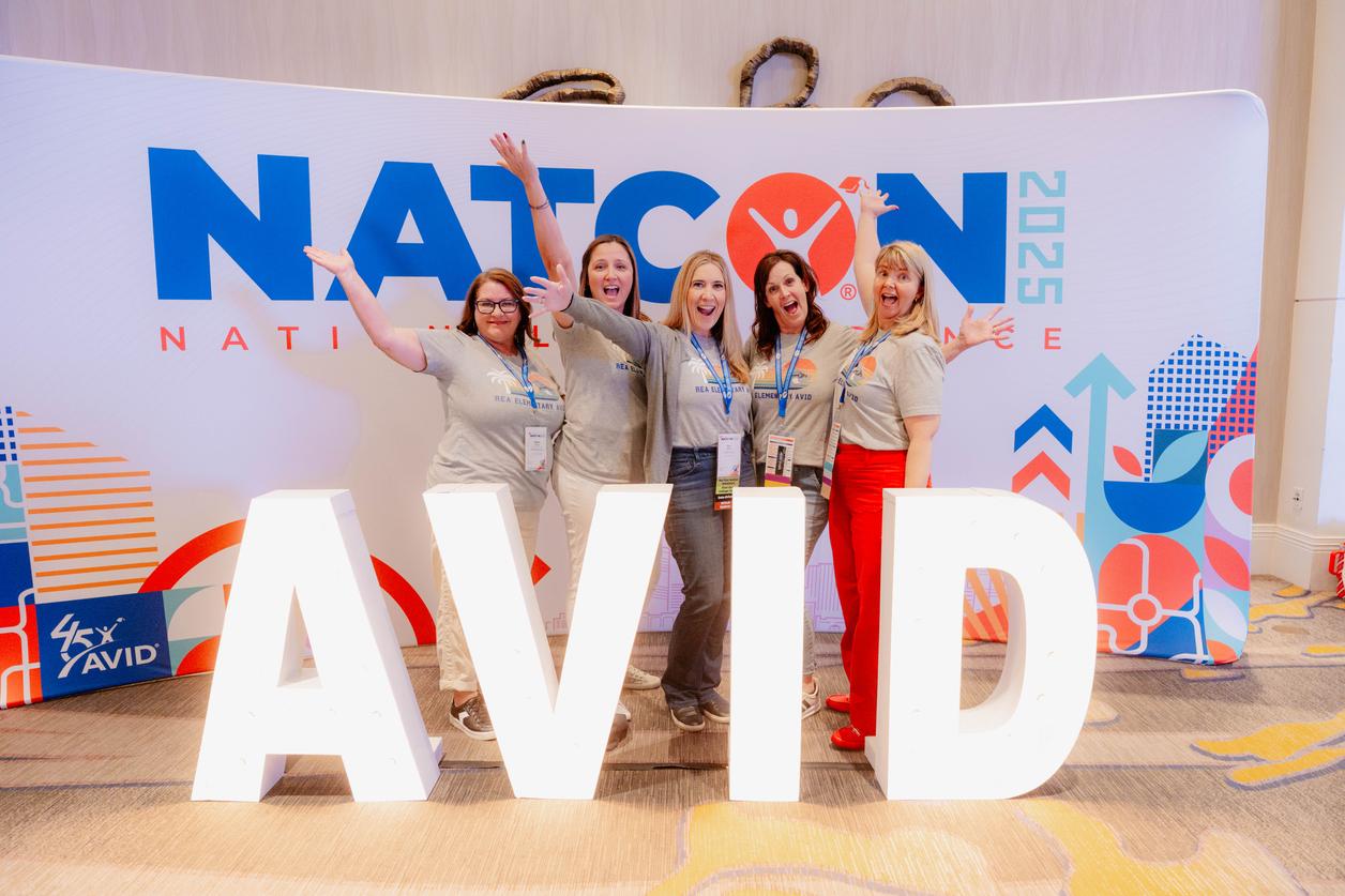 Group of people posing in front of a NATCON 2025 sign with large illuminated AVID letters. Group of people posing in front of a NATCON 2025 sign with large illuminated AVID letters.