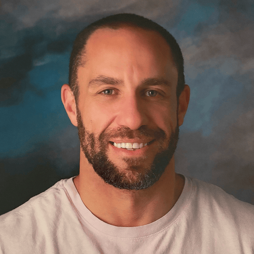 Person with face blurred, wearing a light-colored shirt against a cloudy background. Person with face blurred, wearing a light-colored shirt against a cloudy background.