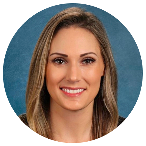 Person with shoulder-length hair in front of a blue background.