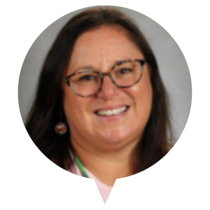 A portrait photo of a person with long dark hair against a grey background.