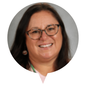 A portrait photo of a person with long dark hair against a grey background. A portrait photo of a person with long dark hair against a grey background.
