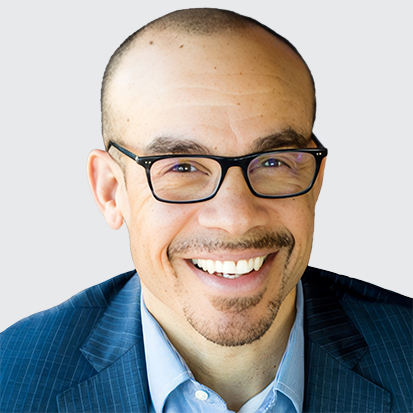 A person in a blue suit jacket and light blue dress shirt.