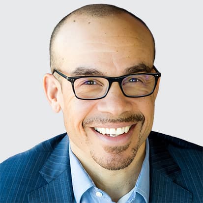 A person in a blue suit jacket and light blue dress shirt. A person in a blue suit jacket and light blue dress shirt.