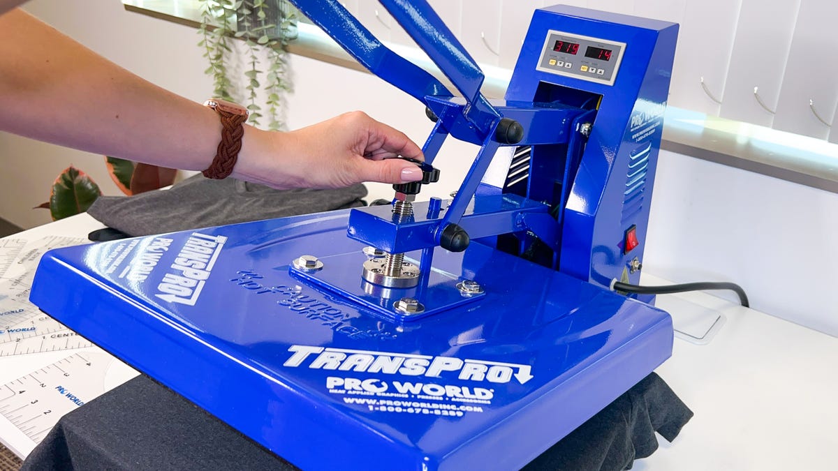 Set the pressure by turning the dial on the clamshell heatpress.