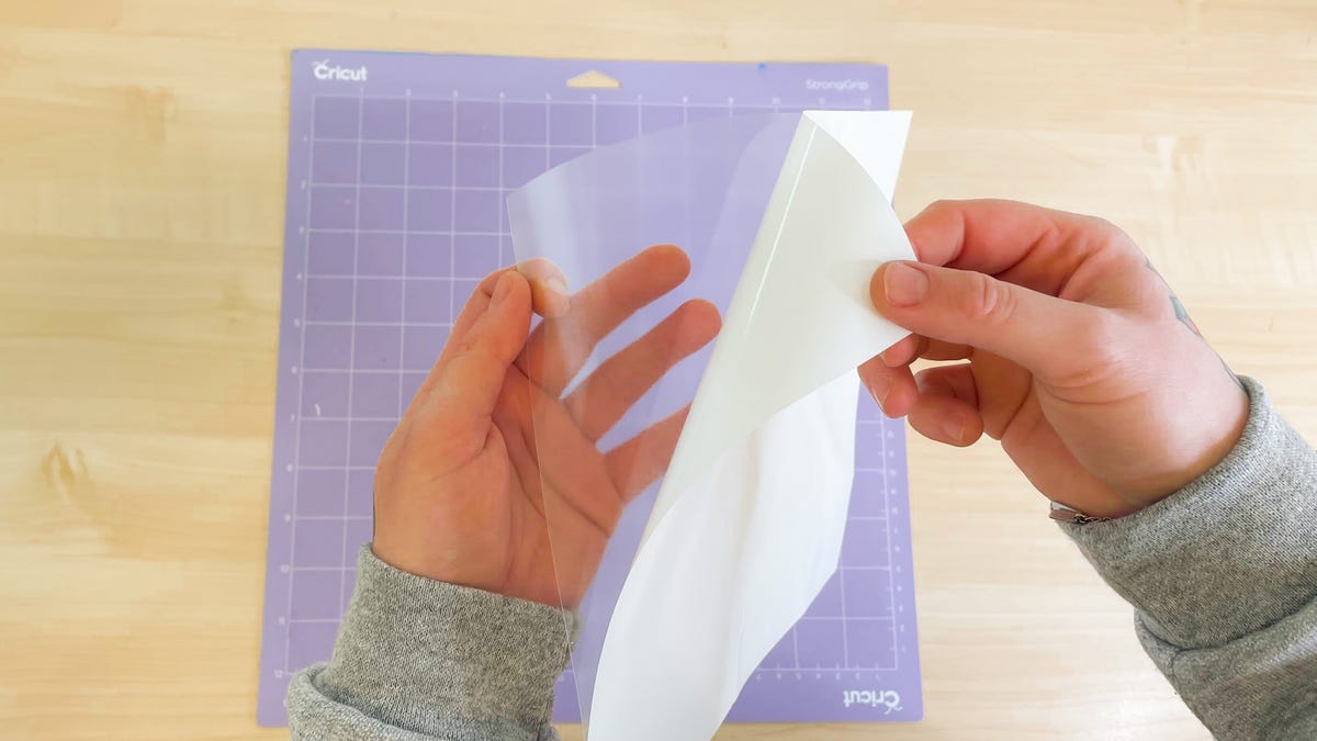Peeling the heat transfer paper off its carrier.