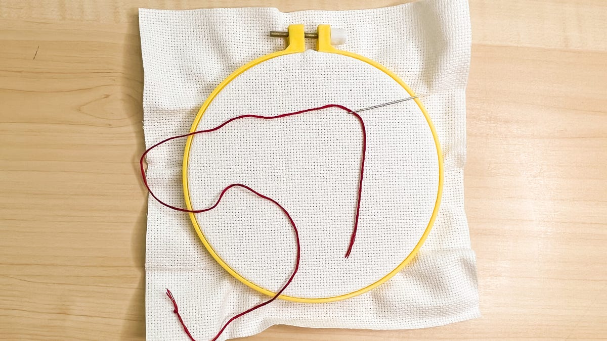 Single-thread embroidery floss with the end tied.