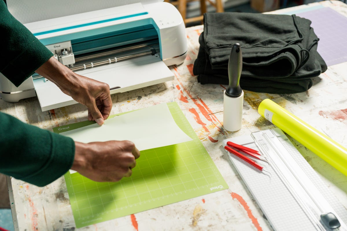 Heat transfer vinyl getting applied on a standard grip cutting mat.