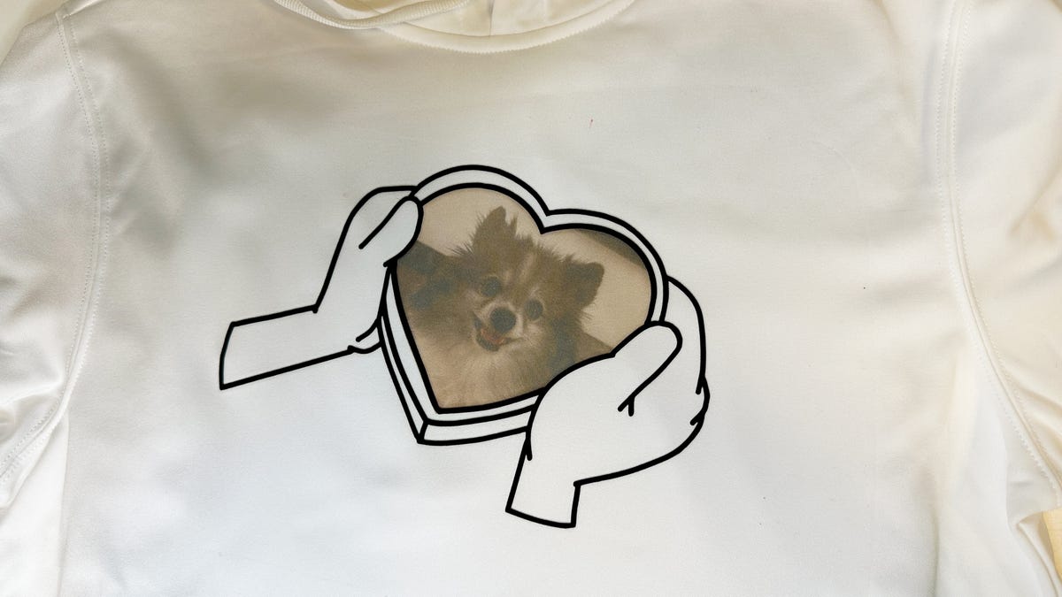 Black HTV outline of two hands holding a heart frame with a Pomeranian dog.