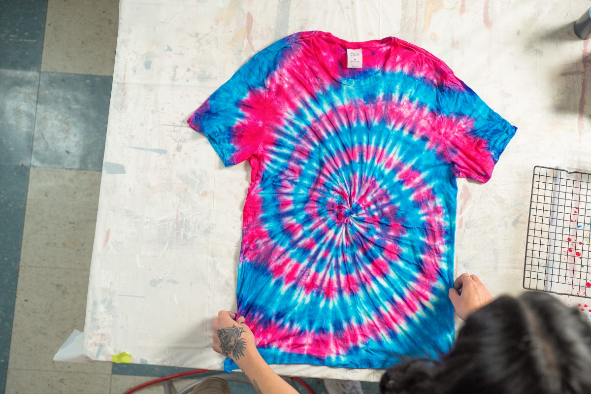 End result of a spiral tie-dyed t-shirt with red and blue dye.