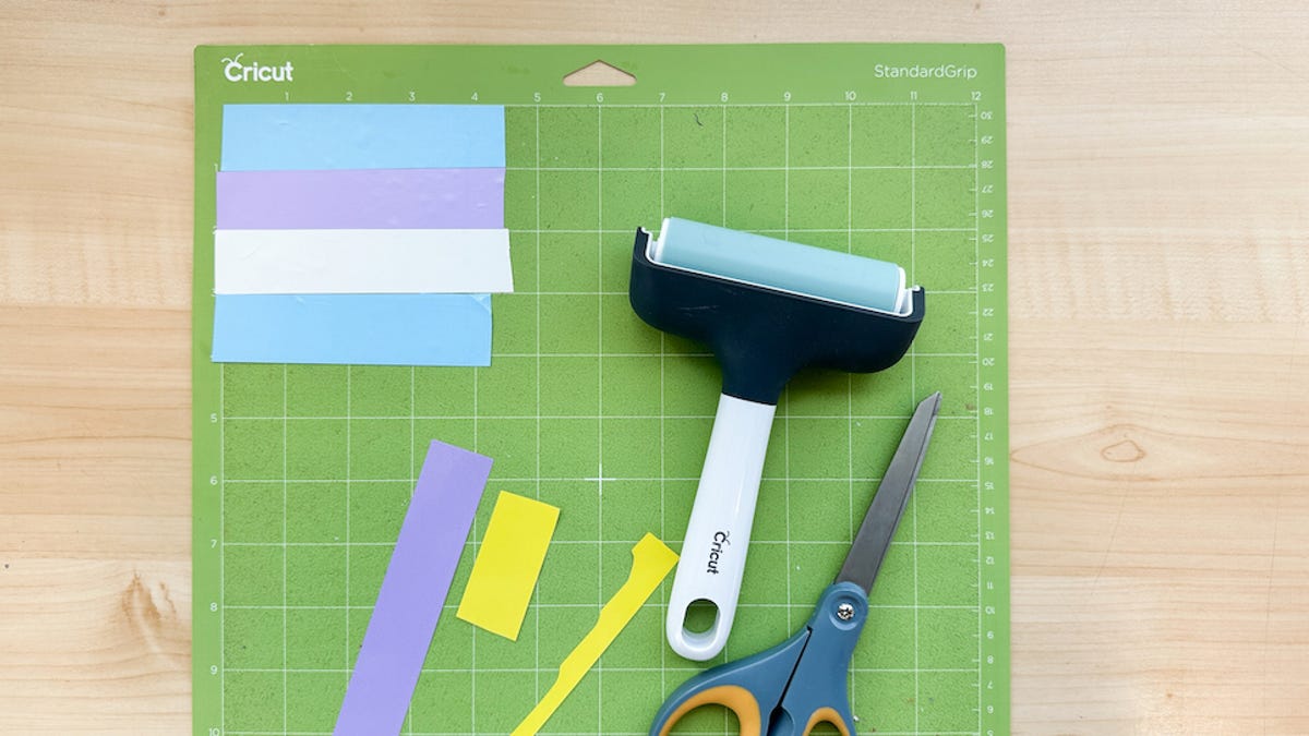 Materials needed for this project includes different colored HTV, a brayer tool, scissors, and weeding tool.