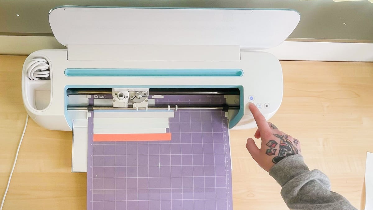 Cutting the design using a vinyl cutting machine like a Cricut.