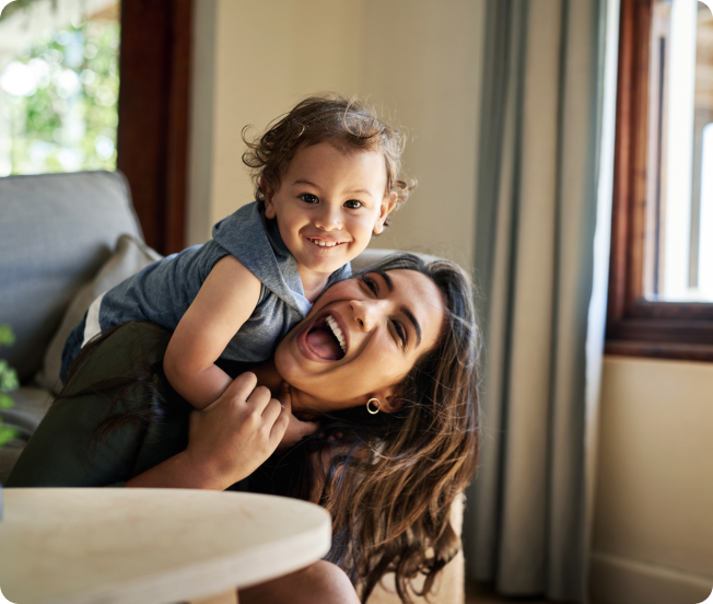 A woman and a baby laughing and smiling