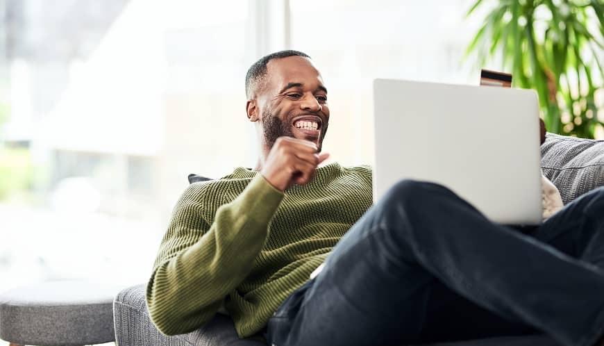 Man on laptop on his couch