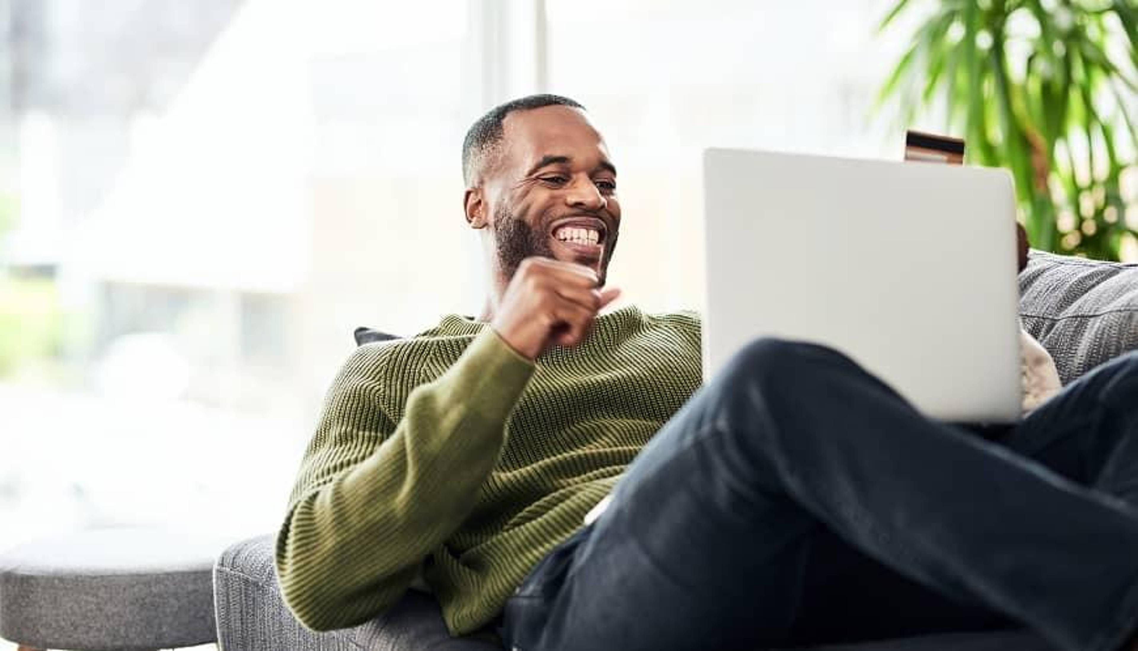 Man on laptop on his couch