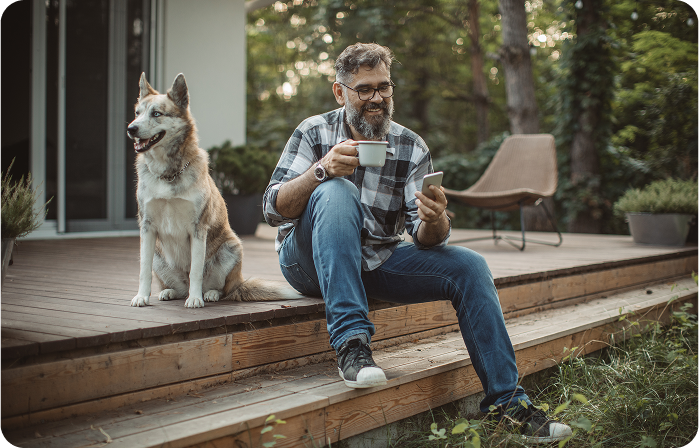 Man sitting on a deck with a dog