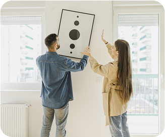Couple putting up wall art
