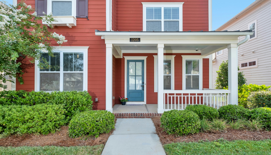 Two-story home with a cement walking path