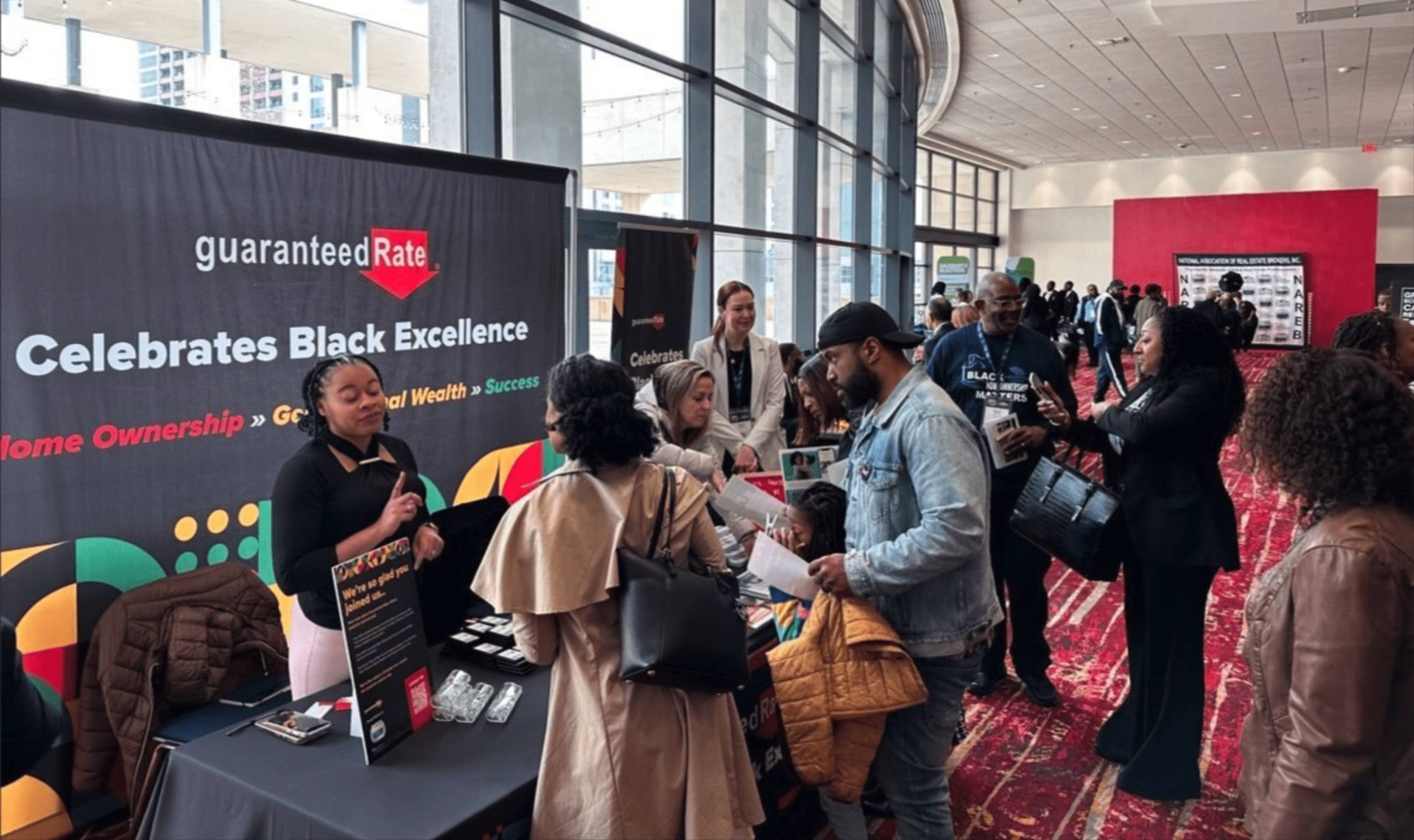 Rate team members welcoming visitors at the Guaranteed Rate Celebrates Black Excellence booth.